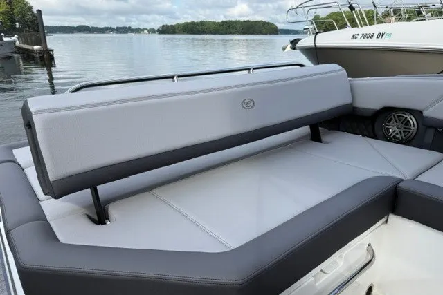 Slide: The Image of 2024 Cobalt R8 boat with sleek seating, docked on a serene lake. - 27