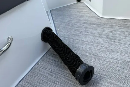Slide: The Image of 2024 Cobalt R8 boat interior with flexible black hose on textured flooring. - 41