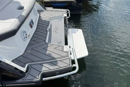 Slide: The Image of 2024 Cobalt R8 boat stern with swim platform on water. - 31