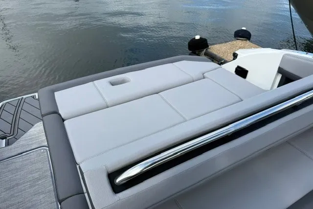 Slide: The Image of 2024 Cobalt R8 boat with sleek sunbed and chrome railing by the water. - 28