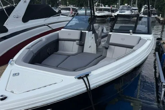 Slide: The Image of 2024 Cobalt R8 boat with sleek design and spacious seating, docked at a marina. - 22