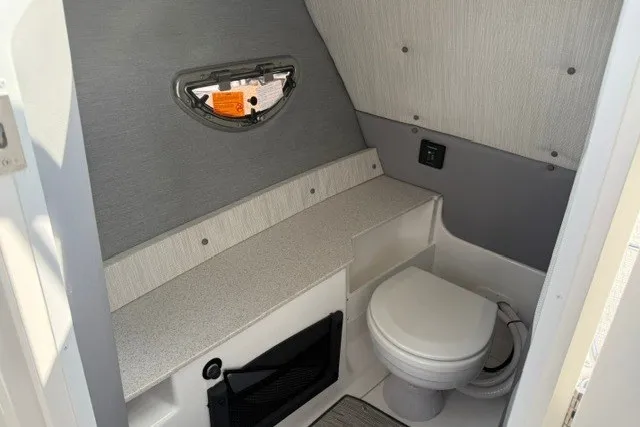 Slide: The Image of 2024 Cobalt R8 boat interior bathroom with modern design and compact toilet. - 20