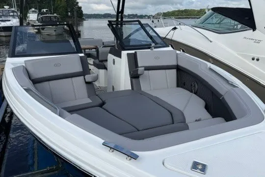 Slide: The Image of 2024 Cobalt R8 boat with sleek gray seating, docked by the water. - 24