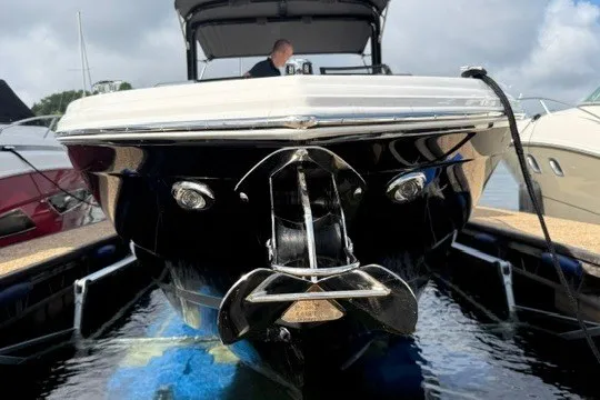 Slide: The Image of 2024 Cobalt R8 boat docked, front view with anchor, calm water reflection. - 39