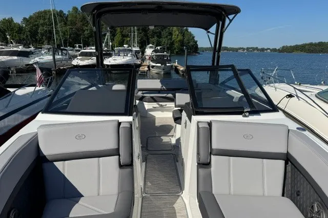 Slide: The Image of 2024 Cobalt R8 boat interior with gray seating, docked at a marina. - 21