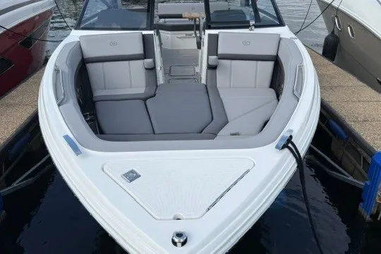 Slide: The Image of 2024 Cobalt R8 boat with spacious seating, docked at a marina. - 23