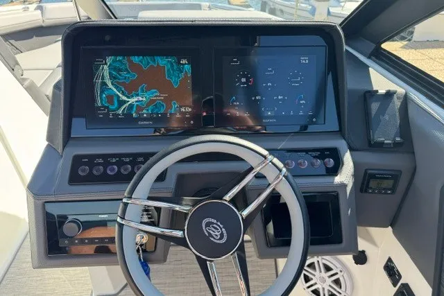 Slide: The Image of 2024 Cobalt R8 boat dashboard with navigation screens and modern steering wheel. - 16