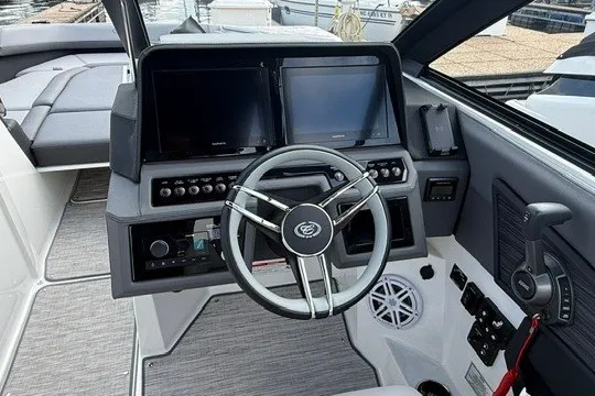 Slide: The Image of 2024 Cobalt R8 boat cockpit with dual screens and modern steering wheel. - 17