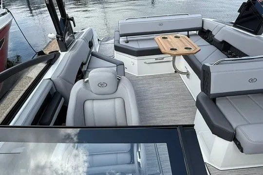 Slide: The Image of 2024 Cobalt R8 boat interior with luxurious seating and a wooden table on the water. - 13