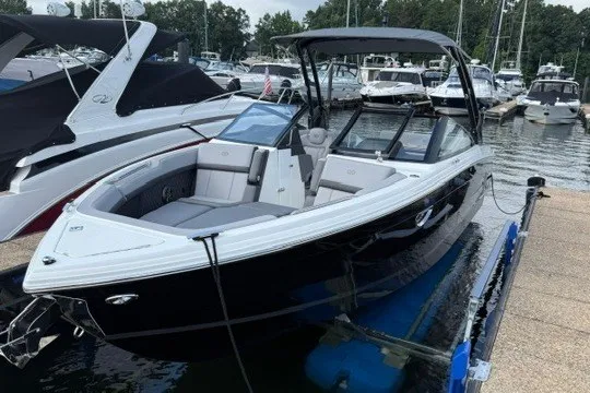 Slide: The Image of 2024 Cobalt R8 boat docked at marina, featuring sleek black and white design. - 4