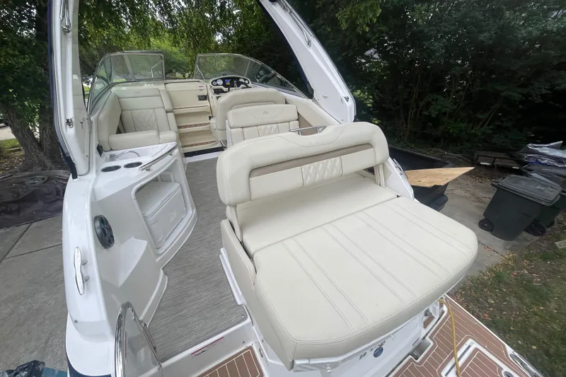 Slide: The Image of 2019 Regal 28 Express boat with spacious white seating and modern interior design. - 14