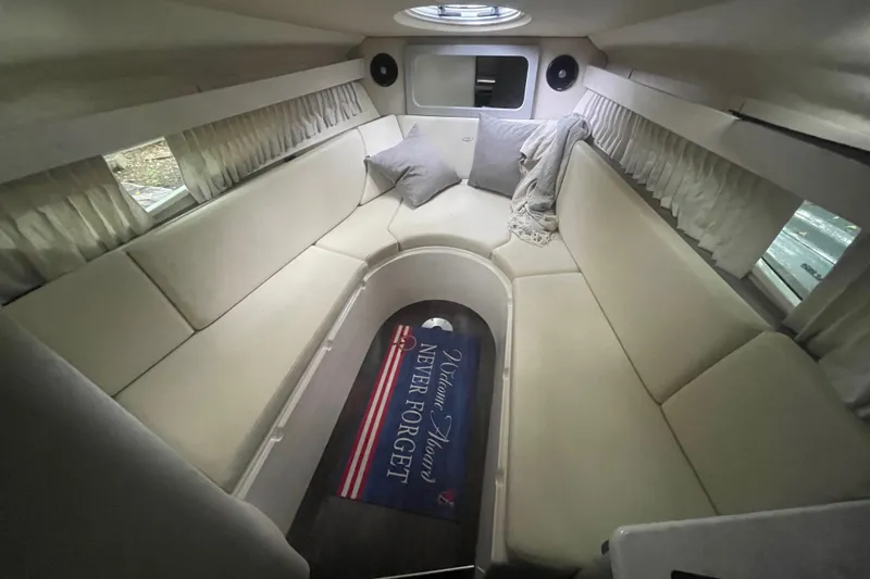 Slide: The Image of Interior of 2019 Regal 28 Express boat with cozy seating and decorative rug. - 7