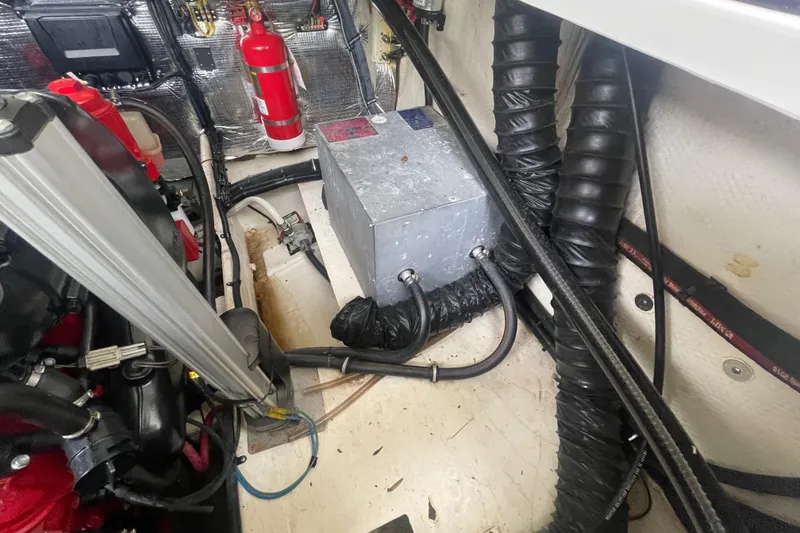 Slide: The Image of Engine compartment of a 2019 Regal 28 Express boat with fire extinguisher and ventilation hoses. - 35
