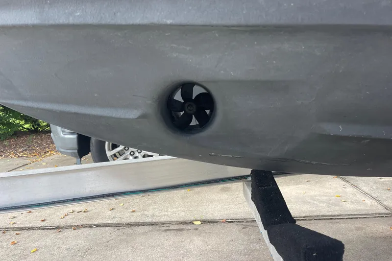 Slide: The Image of 2019 Regal 28 Express boat hull with visible thruster on trailer. - 39