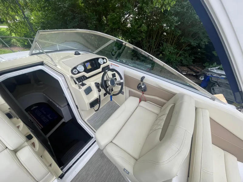 Slide: The Image of 2019 Regal 28 Express boat interior with steering wheel and dashboard controls. - 23