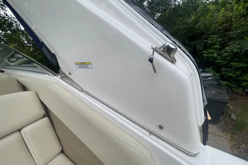 Slide: The Image of 2019 Regal 28 Express boat interior with open hatch and key. - 42