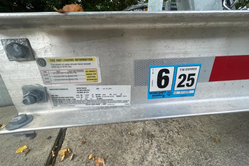 Slide: The Image of Tire and loading information on a 2019 Regal 28 Express trailer. - 49