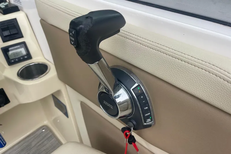 Slide: The Image of Throttle control lever on a 2019 Regal 28 Express boat dashboard. - 29