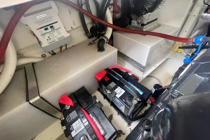 Slide: The Image of Engine compartment of a 2019 Regal 28 Express with batteries and wiring. - 34