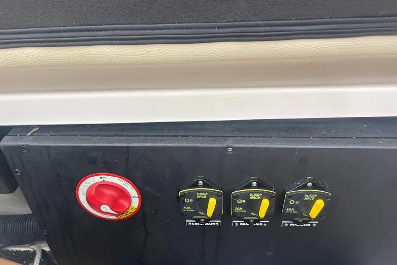 Slide: The Image of Control panel of a 2019 Regal 28 Express boat with switches and a red dial. - 36