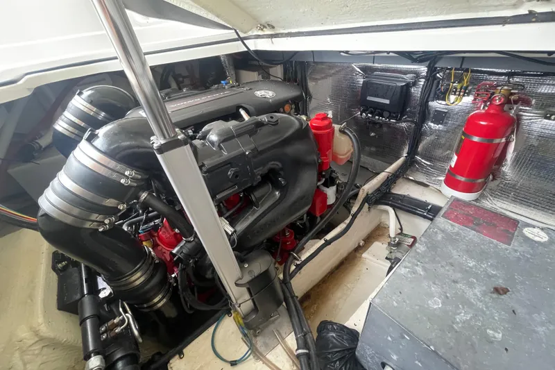 Slide: The Image of Engine compartment of a 2019 Regal 28 Express boat, featuring a well-maintained engine. - 32