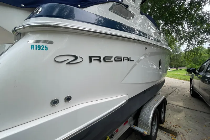 Slide: The Image of 2019 Regal 28 Express boat on trailer, parked outdoors. - 38