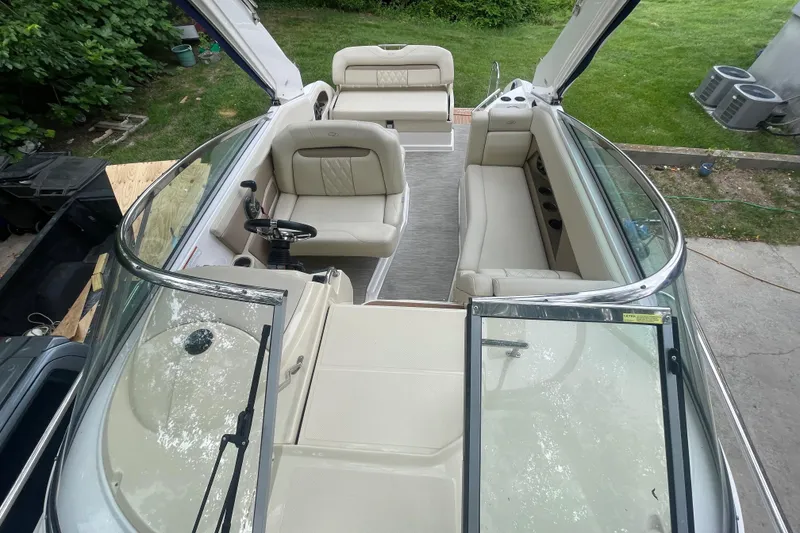 Slide: The Image of 2019 Regal 28 Express boat interior with beige seating and open cockpit view. - 19