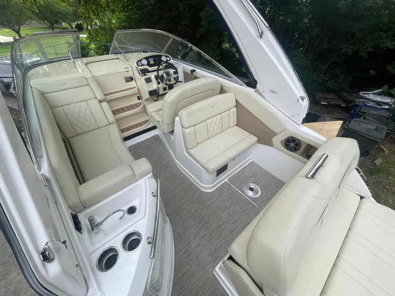 Slide: The Image of 2019 Regal 28 Express boat interior with beige seating and modern dashboard. - 13