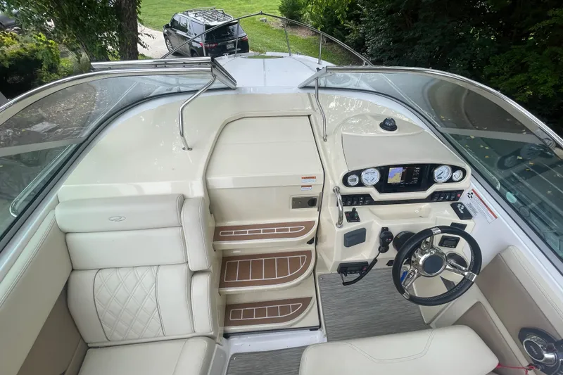 Slide: The Image of 2019 Regal 28 Express boat interior with steering wheel, dashboard, and seating. - 20