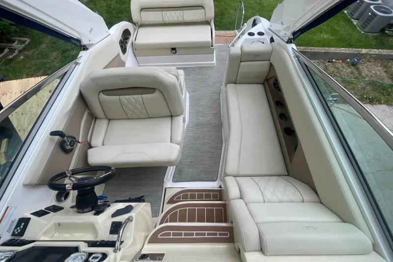 Slide: The Image of 2019 Regal 28 Express boat interior with beige seating and steering wheel. - 18