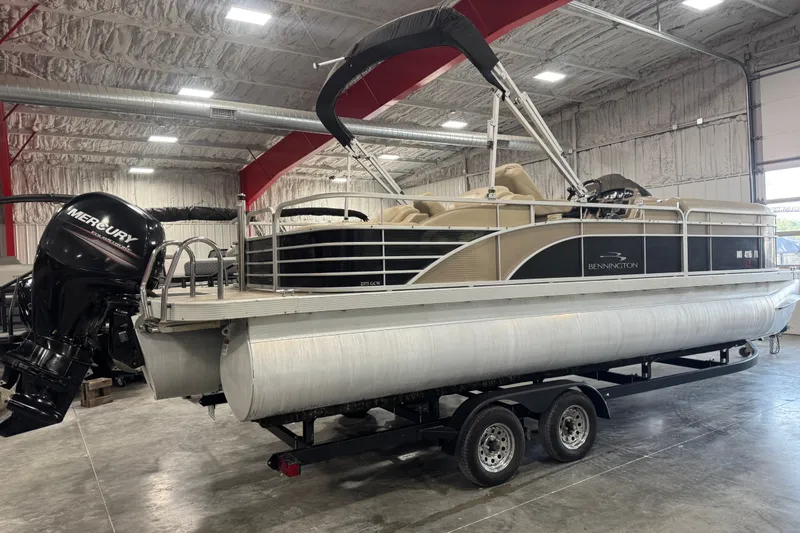 Slide: The Image of 2013 Bennington 2375 GCW pontoon boat with Mercury engine in a warehouse setting. - 3