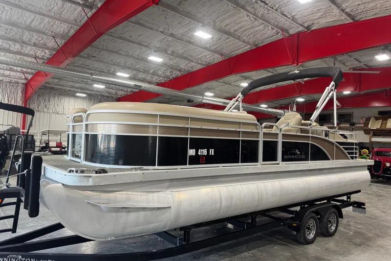 Slide: The Image of 2013 Bennington 2375 GCW pontoon boat on trailer in indoor storage facility. - 2