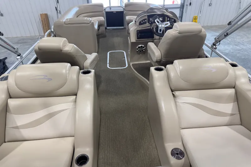 Slide: The Image of 2013 Bennington 2375 GCW boat interior with beige seating and steering console. - 13