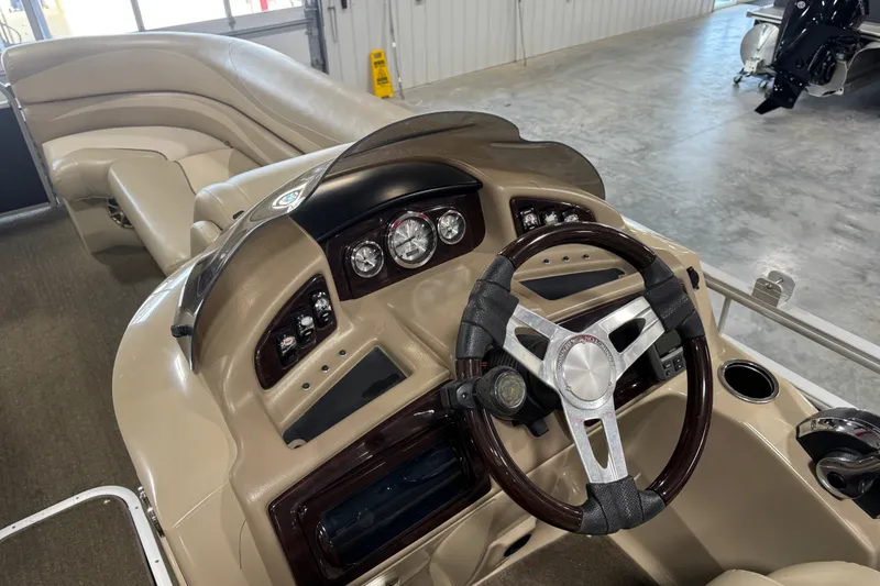 Slide: The Image of 2013 Bennington 2375 GCW boat dashboard with steering wheel and control panel. - 11