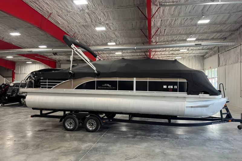 Slide: The Image of 2013 Bennington 2375 GCW pontoon boat on trailer in indoor storage facility. - 7