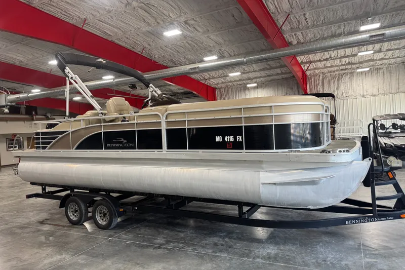 The Image of 2013 Bennington 2375 GCW pontoon boat on trailer in indoor storage facility. - 1