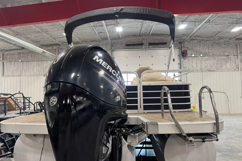 Slide: The Image of 2013 Bennington 2375 GCW pontoon boat with Mercury outboard motor in indoor storage. - 6