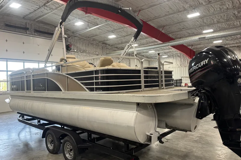 Slide: The Image of 2013 Bennington 2375 GCW pontoon boat with Mercury engine in a warehouse setting. - 4