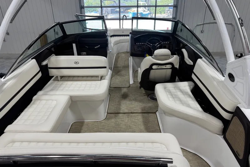 Slide: The Image of Interior of a 2020 Cobalt R5 boat with white seating and modern dashboard. - 8