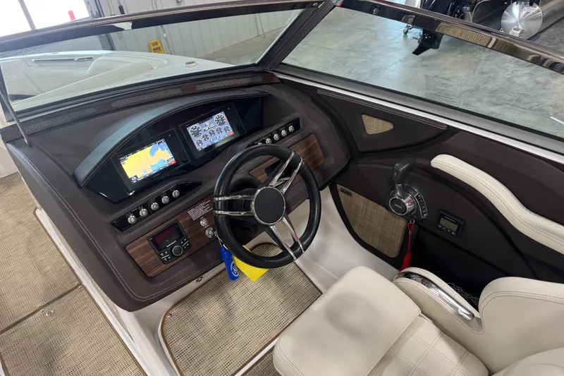 Slide: The Image of 2020 Cobalt R5 boat dashboard with steering wheel, navigation screens, and control panel. - 10