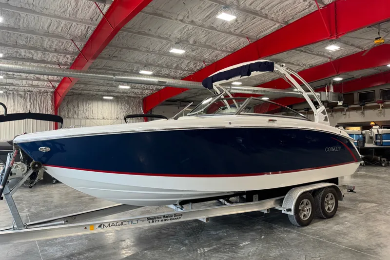 Slide: The Image of 2020 Cobalt R5 boat on trailer in indoor showroom with red beams. - 2