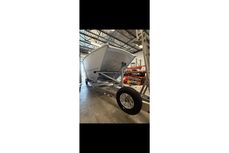Slide: The Image of 2023 Freeman 37 boat on trailer in warehouse setting. - 48