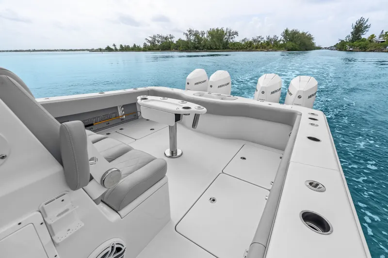 Slide: The Image of 2023 Freeman 37 boat with Mercury engines cruising on clear blue water. - 23