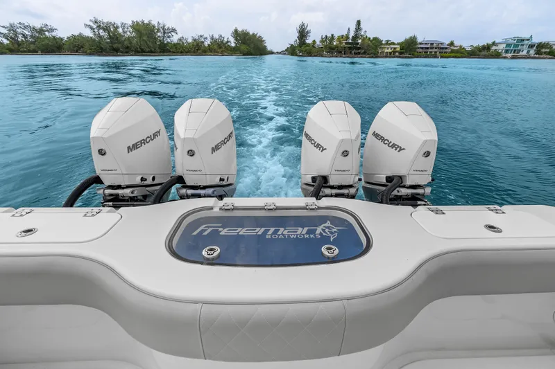 Slide: The Image of Freeman 37 boat with four Mercury engines cruising on clear blue water, 2023 model. - 28