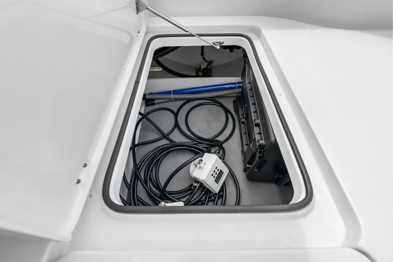 Slide: The Image of Open storage compartment on 2023 Freeman 37 boat with cables and equipment inside. - 45