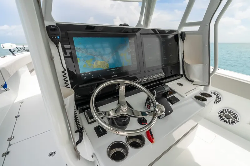 Slide: The Image of 2023 Freeman 37 boat helm with advanced navigation screens and steering wheel. - 19