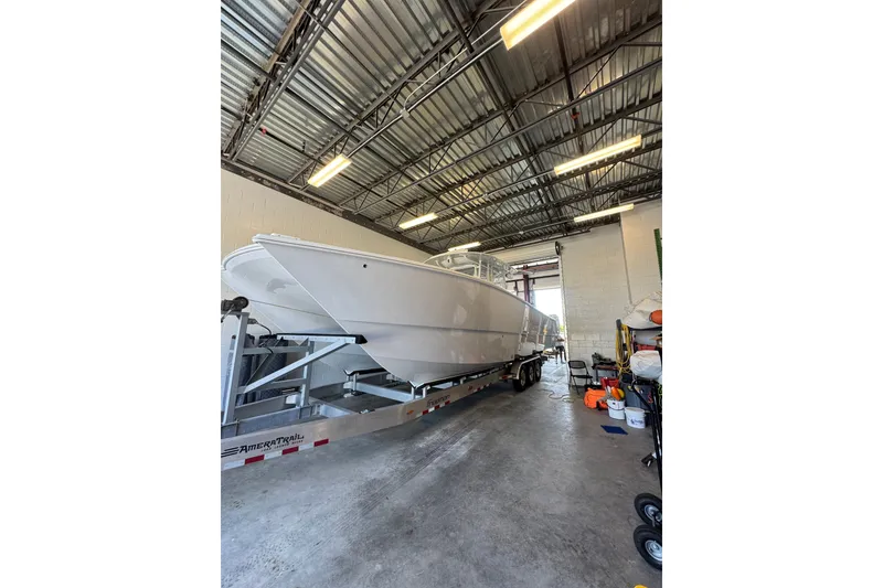 Slide: The Image of 2023 Freeman 37 boat on trailer in a warehouse setting. - 47