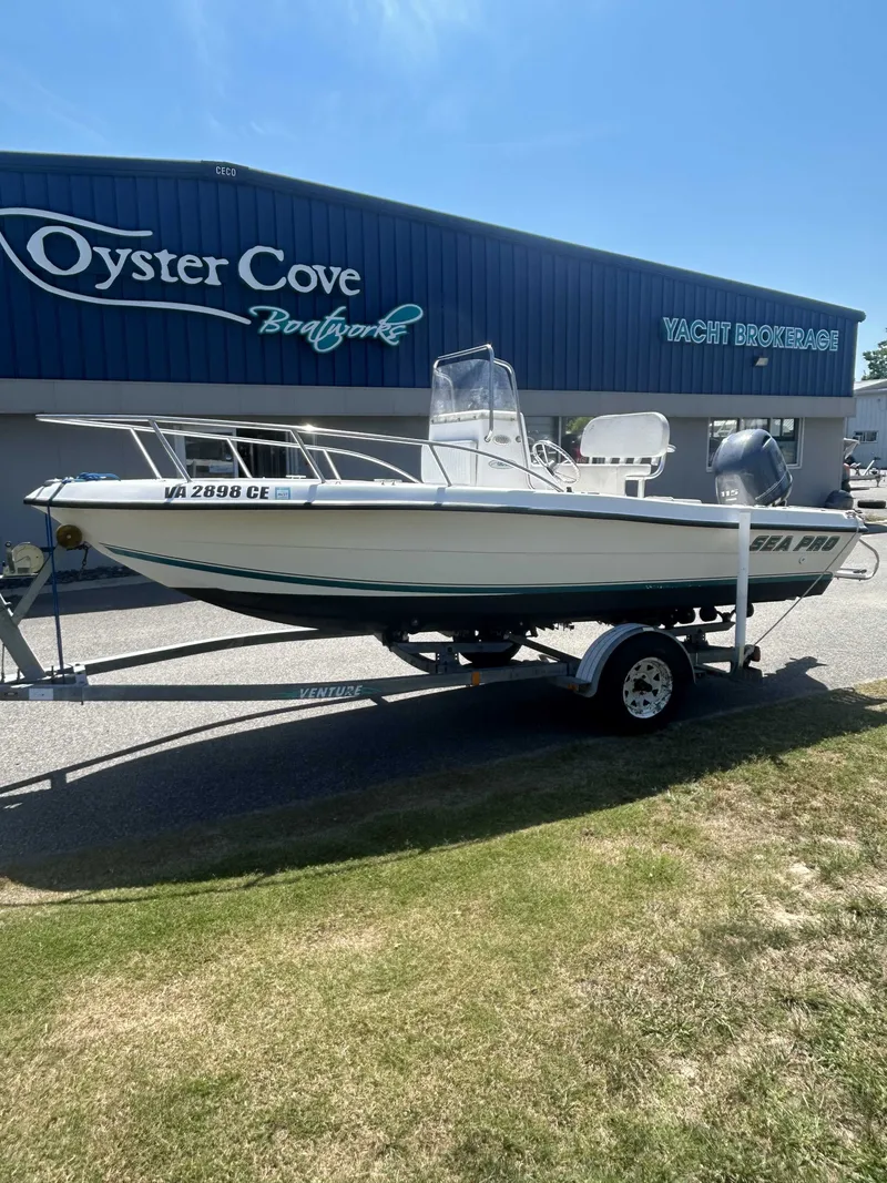 The Image of A 2000 Sea Pro 180 CC boat on a trailer in front of a yacht brokerage building. - 1