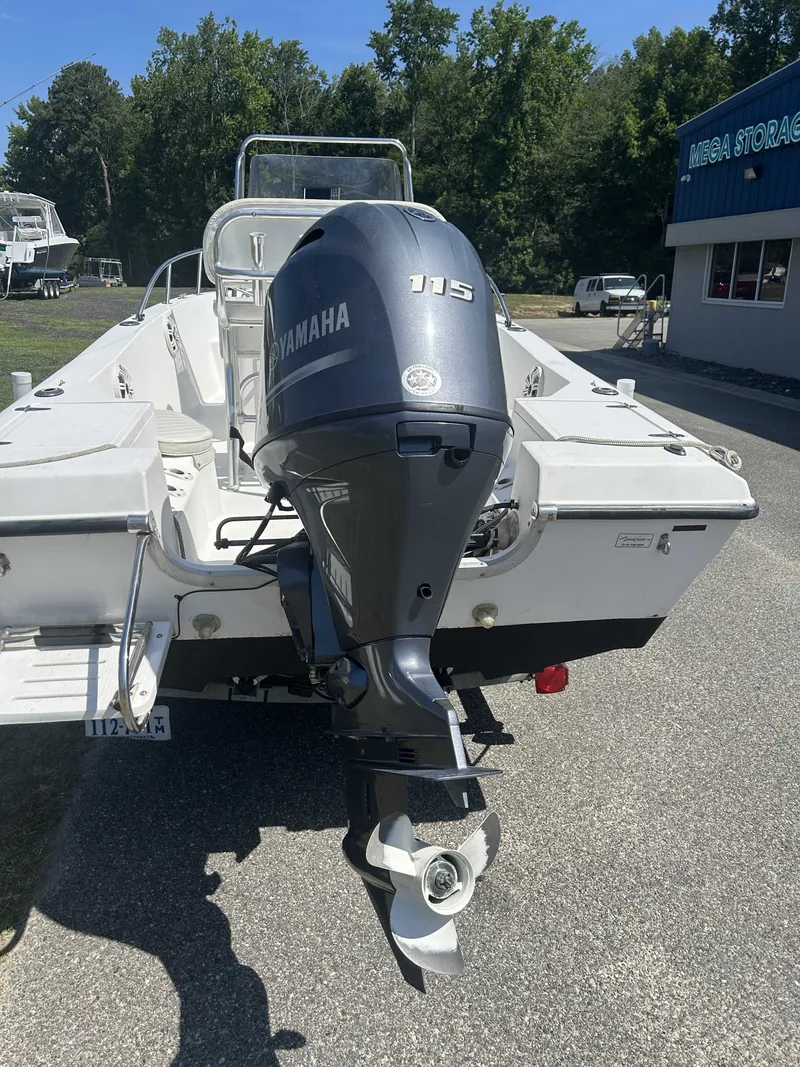Slide: The Image of A 2000 Sea Pro 180 CC boat with a Yamaha 115 outboard motor, parked in a lot. - 4