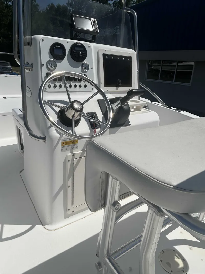Slide: The Image of The image shows the helm of a 2000 Sea Pro 180 CC boat with steering wheel and instruments. - 3